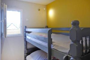 a bedroom with two bunk beds and a window at Baie du Mont Saint Michel / Gîte de la Vaquerie 23 in Vains