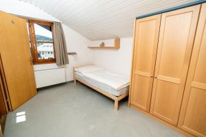 a small bedroom with a bed and a window at City Center Apartment Kitzbühel in Kitzbühel