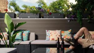 a man sitting on a couch on a patio at Pfefferbett Hostel in Berlin
