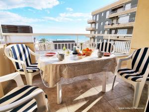 a table on a balcony with a view of the ocean at Sublime sea view apartement in Calafell