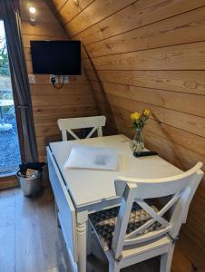 a small table and two chairs in a tiny house at Glamping at Honnington Farm in Royal Tunbridge Wells