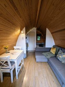 a living room with a couch and a table at Glamping at Honnington Farm in Royal Tunbridge Wells