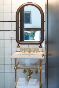 a bathroom with a sink and a mirror at Guild House Hotel in Philadelphia