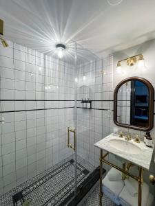 a bathroom with a sink and a mirror at Guild House Hotel in Philadelphia