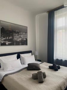 a bedroom with a large bed with two pillows on it at Bärliner Hotel in Erfurt