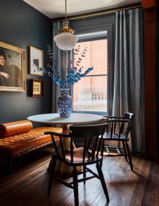 a dining room with a table and chairs and a couch at Guild House Hotel in Philadelphia