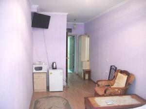 a living room with a tv on the wall at B&B Aktau НЕ ОТЕЛЬ in Aktau
