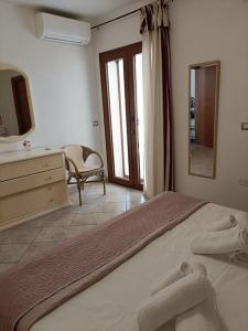 um quarto com uma cama, uma cómoda e um espelho em Giarranas House - Apartment with coutyard em Villacidro