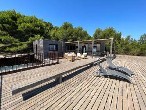 a wooden deck with a house on top of it at Chappert-gaujal in Leucate