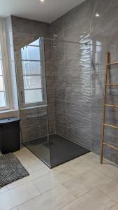 a shower with a glass door in a bathroom at La maison du sabotier in Audressein +47 photos
