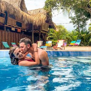 Un hombre y una mujer en la piscina de un resort. en Kanta Sana, en Palomino