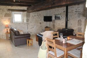 a living room with a couch and a table at Petite Ferme Embir 