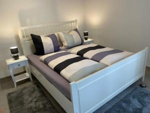 a white bed with pillows on it in a room at Stadtblick Walsrode in Walsrode