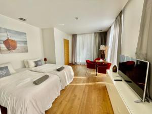 a hotel room with a bed and a television at SURF HOUSE DREAMERS COAST in Klaipėda