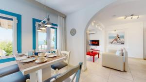 a dining room and living room with a table and chairs at Acrotel Athena Villa in Elia