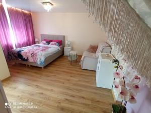 a small bedroom with a bed and a table at Perfect Studio in Narva center in Narva