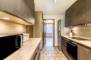 a kitchen with wooden cabinets and a counter top at B463 Penthouse in Albstadt