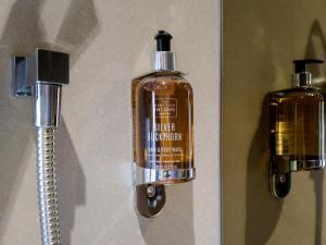 a bottle of soap is hanging on a wall at Bloc Hotel London Gatwick Airport in Horley