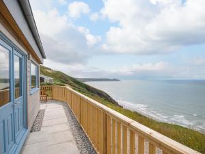 a balcony with a view of the ocean at Solana in Torpoint