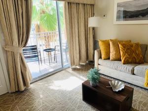 a living room with a couch and a balcony at Amazing 1 Bedroom Resort 2 miles from Universal in Orlando