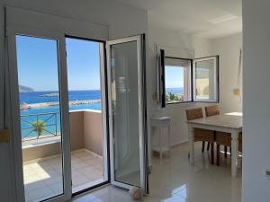 a dining room with a view of the ocean at Locals Apartment Karpathos in Karpathos Town
