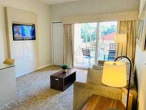 a living room with a couch and a tv at Amazing 1 Bedroom Resort 2 miles from Universal in Orlando