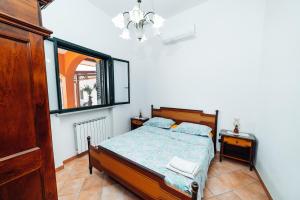 a bedroom with a bed and a window at Villa Maria in Sanarica