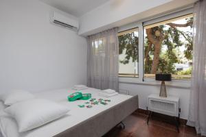 a bedroom with a white bed and a window at Relux Sea View 2BD Apartment by BluPine in Athens