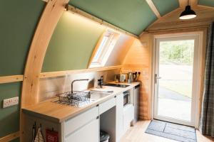 a kitchen in a tiny house with a sink at Wigwam Holidays Forcett Grange in Richmond