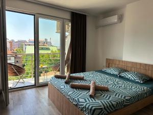 a bedroom with a bed with two logs on it at LINA Studios - City Center in Ohrid