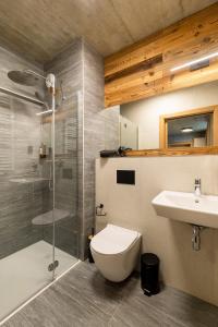 a bathroom with a toilet and a sink and a shower at XYZ eXtreme You Zen in Szczyrk