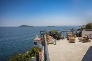 a balcony with a view of the water at The Rock in Skiathos Town