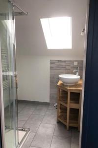a bathroom with a sink and a glass shower at Etape de Bel Air in Droiturier +12 photos