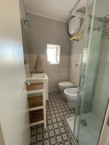 a bathroom with a toilet and a sink and a shower at Casa Marina in Scilla +12 photos