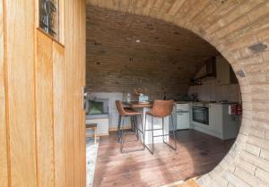 a kitchen with a table and chairs in a room at Hares View in Rhayader