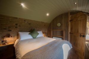 a bedroom with a bed in a room with wooden walls at Hares View in Rhayader