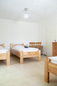 a bedroom with two beds and a dresser in it at Ubytování Kateřina in Skalná