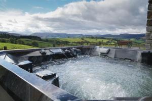a large pool of water with a bench in it at Hares View in Rhayader