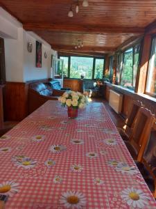 a table with a vase of flowers on top of it at Casa Elli in Buşteni +55 photos
