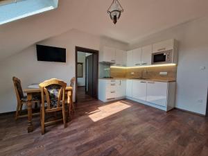 a kitchen and dining room with a table and chairs at Apartmány Slezský Dům in Jeseník