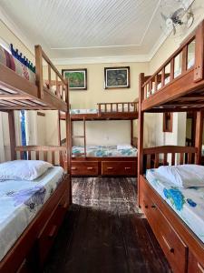 a room with three bunk beds in a house at Hostel Manaus ll in Manaus