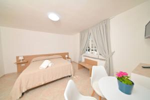 a bedroom with a bed and a table and chairs at Villa Aida in Ischia