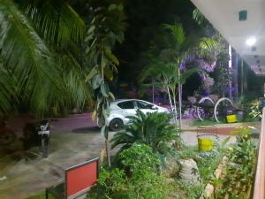 a white car parked in a parking lot at night at New Sunrise Hotel in Batticaloa