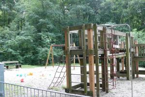 a wooden playground with a slide and a ladder at Ferienwohnung Dittmar am Kaffeehof in Bad Liebenzell