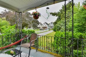 a balcony with a chair and a swing at Themed New York Home about 2 Mi to Niagara Falls! in Niagara Falls