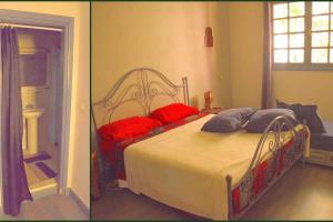 Un dormitorio con una cama con almohadas rojas. en Lot 46 en Souira Kedima
