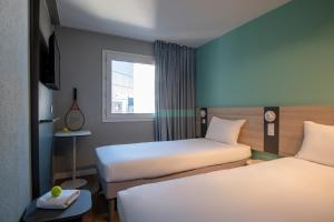 Postel nebo postele na pokoji v ubytování ibis budget Nice Aeroport