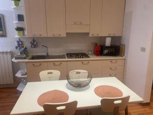 a kitchen with a table with chairs and a sink at Al piccolo castelliere in Trieste