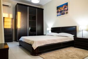 1 dormitorio con 1 cama grande y cabecero negro en Sunset Villa, en Chaniotis