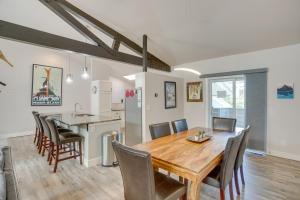 a kitchen and dining room with a wooden table and chairs at Modern Townhome about 4 Miles to Beaver Creek Resort! in Avon